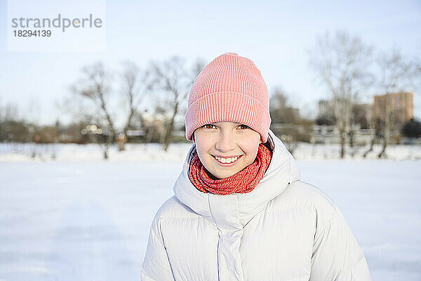 Happy girl wearing knit hat in winter