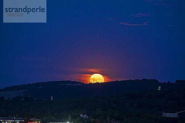 Germany  Bavaria  Wurzburg  Fiery moon rising at night