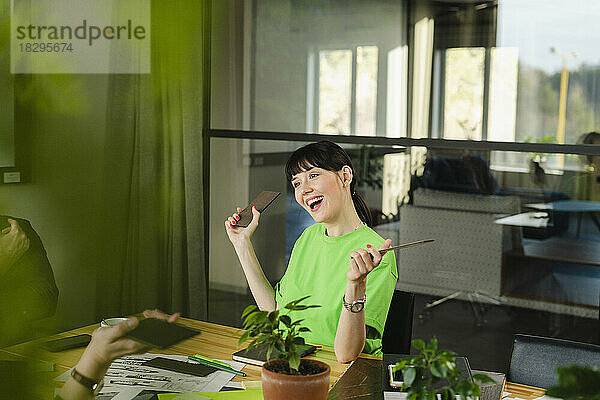 Happy woman in green t-shirt in conference room