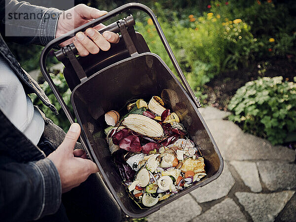 Man holding compost bucket  close up
