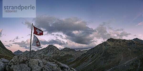 Schweizer Flagge und Flagge des SAC mit Wolkenhimmel bei blauer Stunde und Engadiner Berge  St Moritz  Engadin  Graubünden  Schweiz  Europa