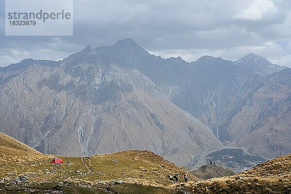 Hochgebirge  Zelt und Wanderer  Gergetier Dreifaltigkeitskirche  Bergkirche Gergeti  Gergetis Sameba  Tsminda Sameba  bei Stepanzminda  Stepantsminda  Region Mzcheta-Mtianeti  Großer Kaukasus  Georgien  Asien