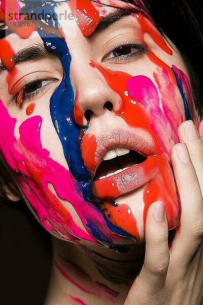 Porträt eines schönen Mädchens mit roter Farbe im Gesicht. Foto im Studio auf einem schwarzen Hintergrund aufgenommen