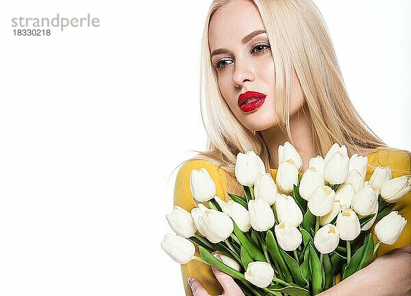 Porträt der schönen Mode-Modell mit Blumenstrauß Lilie in den Händen  süß und sinnlich. Schönheit Make-up  Haare. Bild im Studio auf einem isolierten weißen Hintergrund genommen