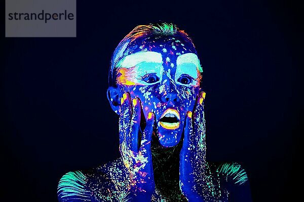 Porträt eines schönen Mädchens mit ultravioletter Farbe im Gesicht. Mädchen mit Neon-Make-up in Farbe Licht