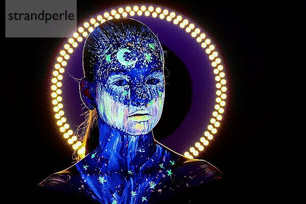 Porträt eines schönen Mädchens mit ultravioletter Farbe im Gesicht. Mädchen mit Neon-Make-up in Farbe Licht