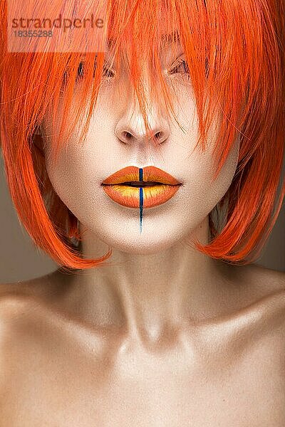 Schönes Mädchen in einem orangefarbenen Perücke Cosplay-Stil mit hellen kreativen Lippen. Kunst Schönheit Bild. Porträtaufnahme im Studio