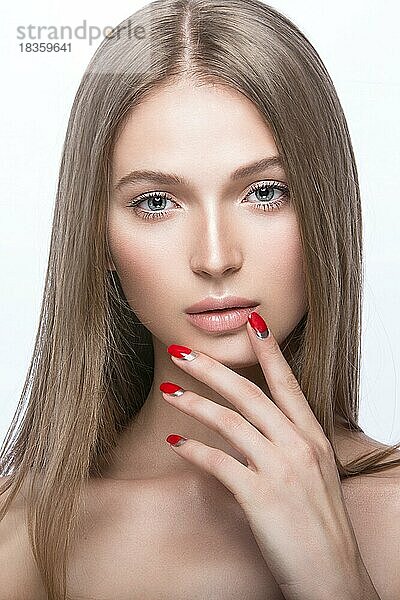Schönes junges Mädchen mit einem hellen Make-up und roten Nägeln. Bild im Studio auf einem weißen Hintergrund aufgenommen