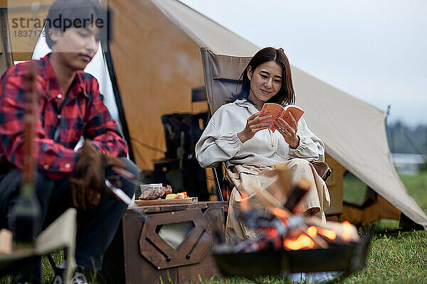 Junges japanisches Paar auf dem Campingplatz