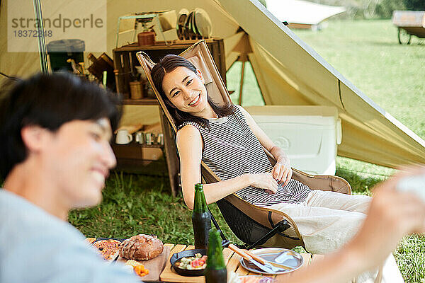 Junges japanisches Paar auf dem Campingplatz