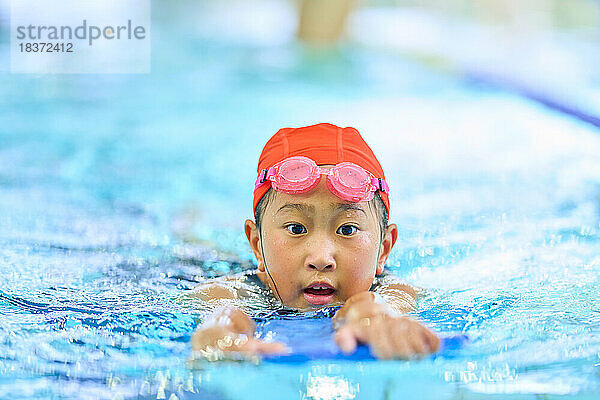 Kid at indoor swimming pool