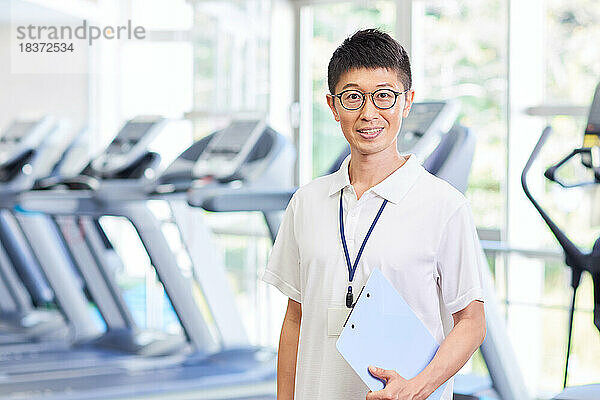 Japanese trainer at indoor gym