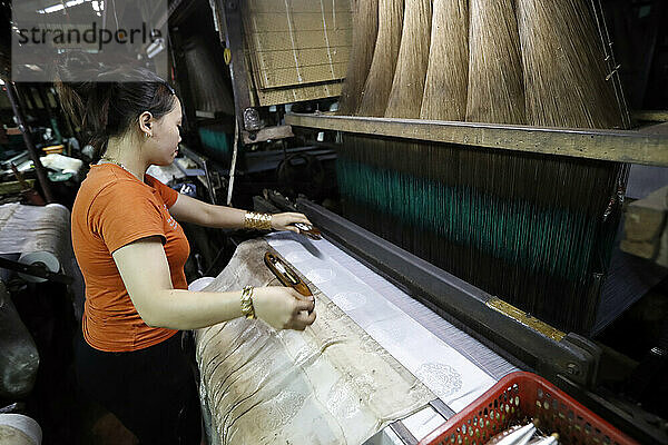 Eine traditionelle Seidenfabrik  Frau arbeitet an einem alten Seidenwebstuhl  Tan Chau  Vietnam  Indochina  Südostasien  Asien
