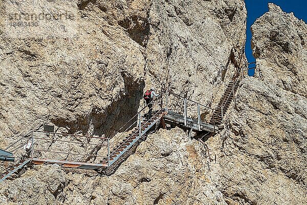 Tourist klettert auf einer am Felsen befestigten Stahltreppe. Dolomiten  Italien  Dolomiten  Italien  Europa