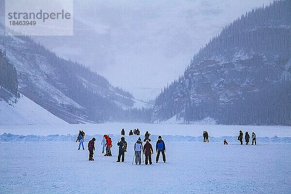 Schlittschuhläufer auf dem zugefrorenen Bergsee Lake Louise nahe Schlosshotel Chateau Lake Louise  Alberta  Kanada  Nordamerika