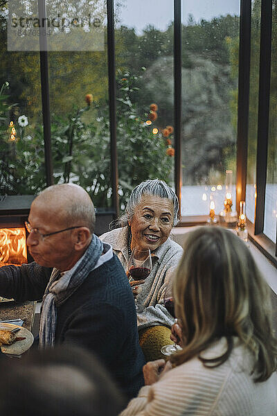 Ältere Freundinnen unterhalten sich während einer Dinnerparty miteinander