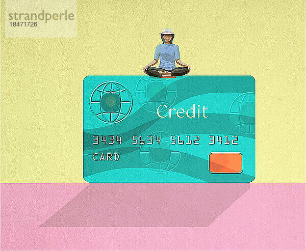 Frau meditiert auf einer übergroßen Kreditkarte