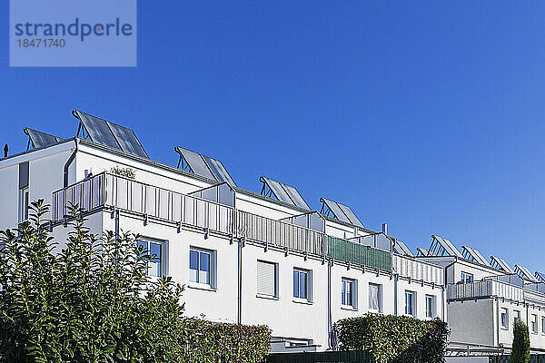 Deutschland  Nordrhein-Westfalen  Köln  klarer Himmel über Vorstadtwohnungen mit Solardachpaneelen