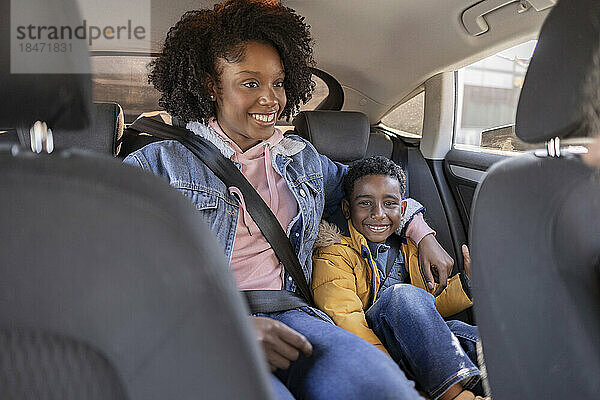 Glückliche Mutter und Sohn sitzen im Auto