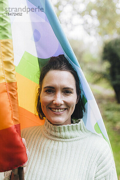 Glückliche Frau mit Regenbogenfahne