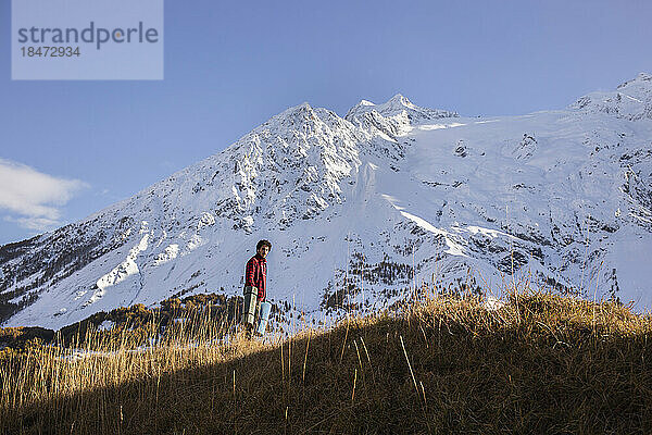 Young man hiking on snowcapped mountain