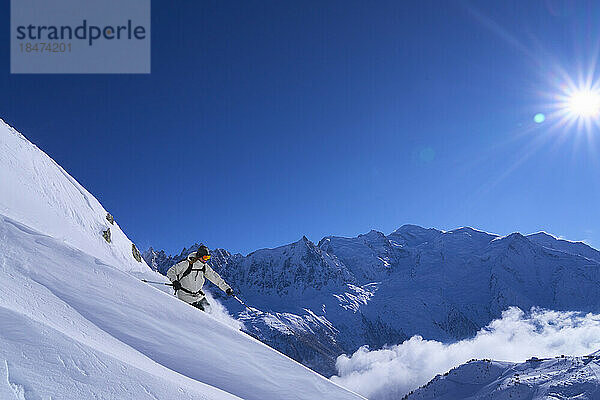 Frau fährt an einem sonnigen Tag im Schnee Ski