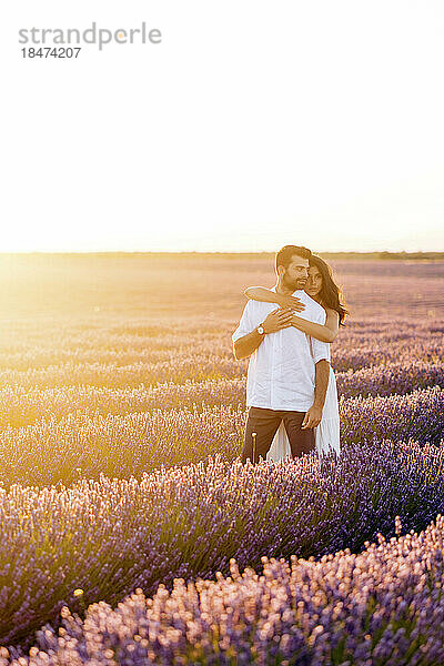 Young woman standing with man in lavender field