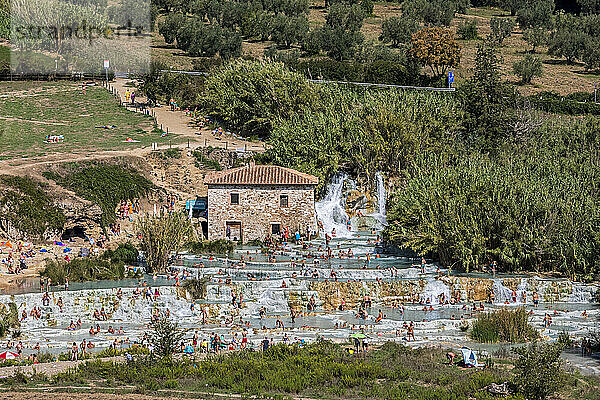 Italy  Tuscany  Saturnia  People bathing in Cascate del Mulino thermal pool