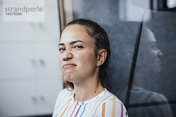 Businesswoman making face sitting in office