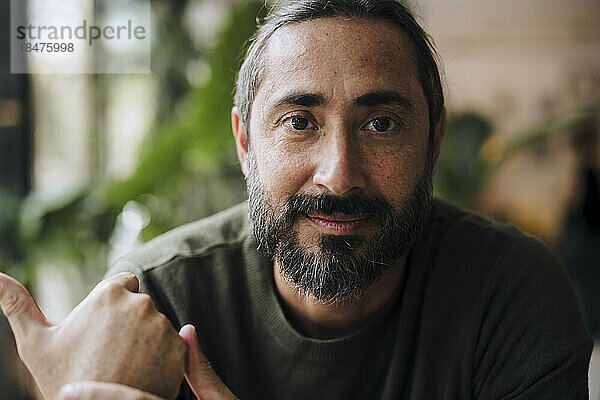 Mature bearded man in cafe