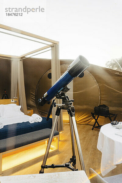 Astronomy telescope on tripod in dome tent
