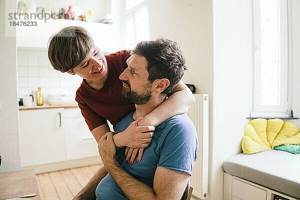 Smiling woman with arm around man at home