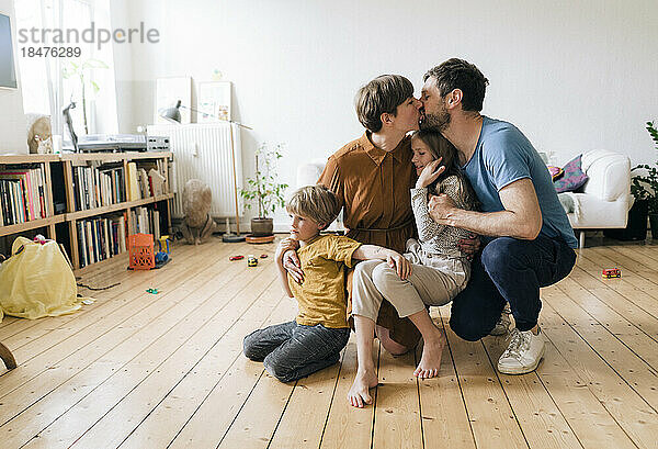 Romantic parents having fun with son and daughter at home