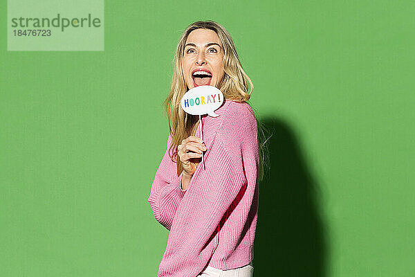 Happy woman with speech bubble against green background