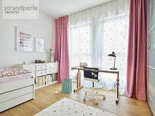 Leeres Arbeitszimmer mit rosa Vorhängen in der Wohnung