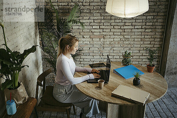 Businesswoman working through laptop at desk in workplace