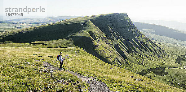 Woman standing at mountain on sunny day  Brecon Beacons  Wales