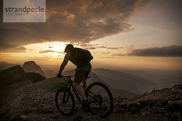 Mountainbiker fährt am Hang am Berg