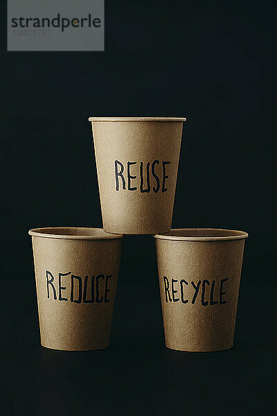 Reusable cups arranged against black background