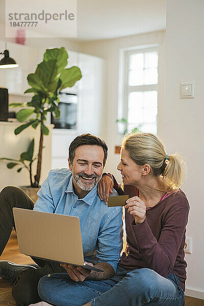 Glückliches Paar genießt es  zu Hause online einzukaufen