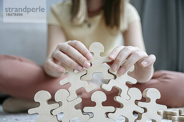 Mädchen spielt zu Hause mit Holzpuzzle