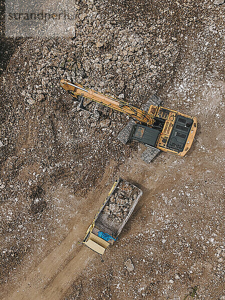 Indonesia  Bali  Aerial view of excavator digging in quarry