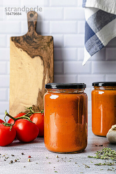 Homemade tomato sauce in jar kept on table