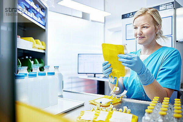 Woman holding scientific sample in a microbiological lab