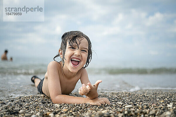Carefree boy enjoying vacation at beach