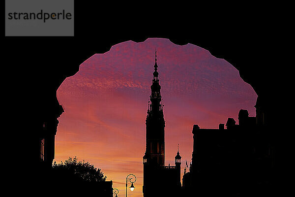 Silhouette of Town Hall Tower and arch of Green Gate at dusk