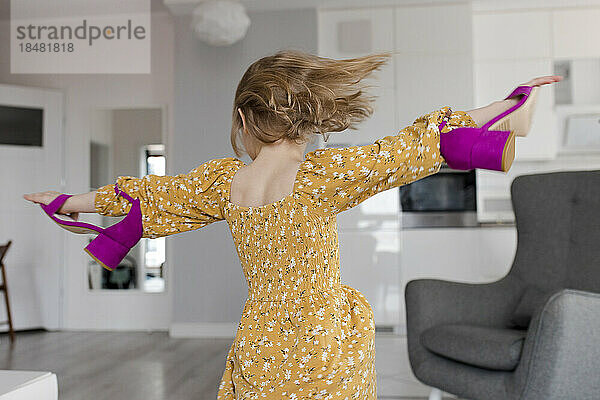 Girl spinning with high heels at home