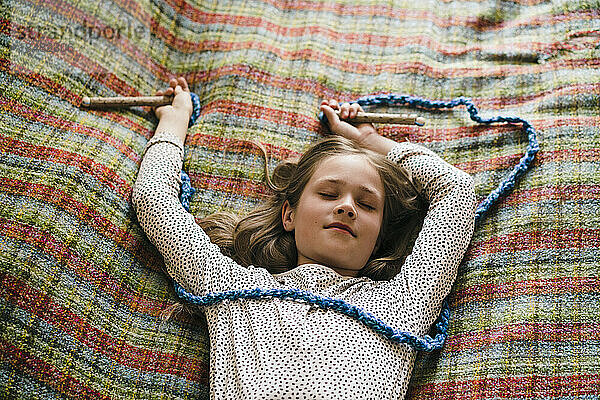 Girl with jump rope sleeping on bed at home