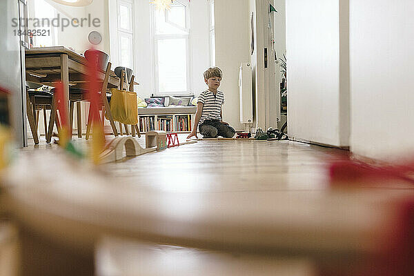 Boy playing with toys sitting at home