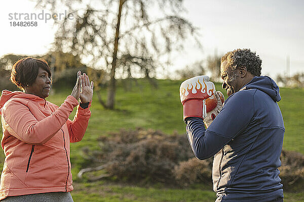 Couple practicing boxing at park